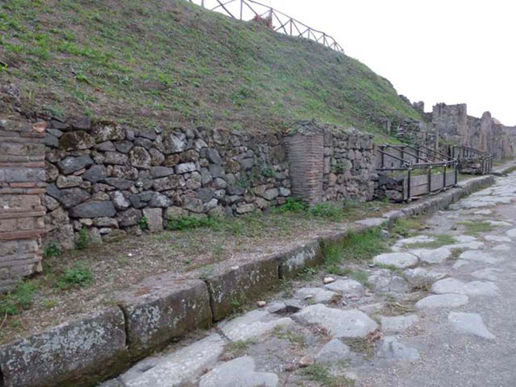 Via di Nola, south side. September 2011. Looking west from near III.9.4, towards unexcavated vicolo, and III.8. Photo courtesy of Michael Binns.