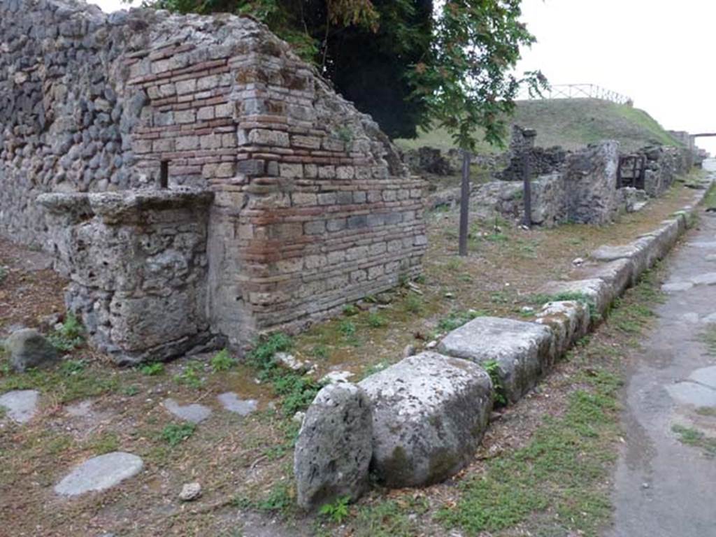 Via di Nola, south side, September 2011. Looking west towards unexcavated vicolo with street altar, on left, and III.10.6 on right.  Photo courtesy of Michael Binns.