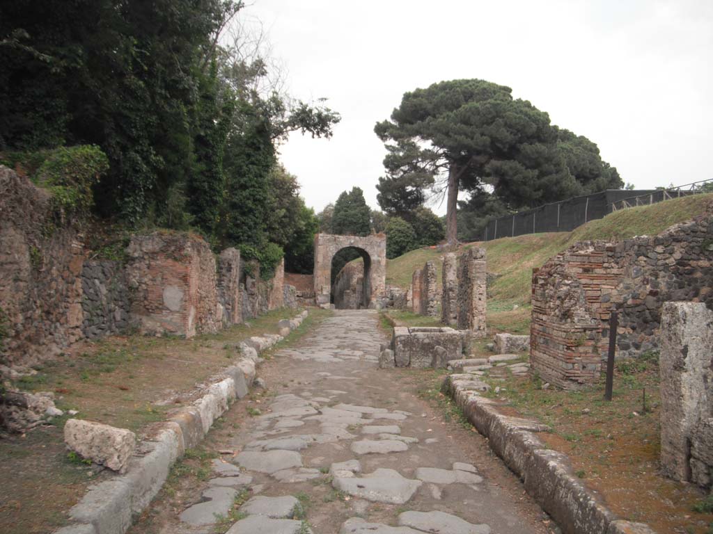Via di Nola, Pompeii.  May 2011. 
Looking east towards Nola Gate, with IV.4, on left and III.10, on right. Photo courtesy of Ivo van der Graaff.