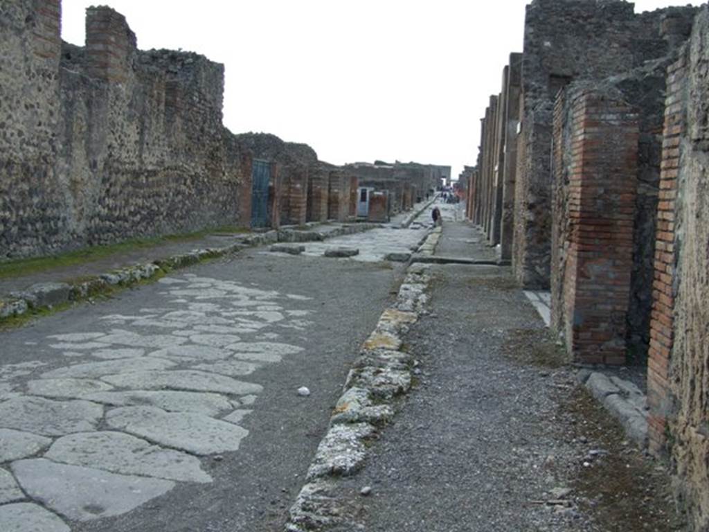 Via di Nola between IX.4 and V.2. Looking west towards the crossroads and Via della Fortuna. March 2009. The entrance to Vicolo di Cecilio Giocondo can be seen on the right, where the stepping stones cross Via di Nola.