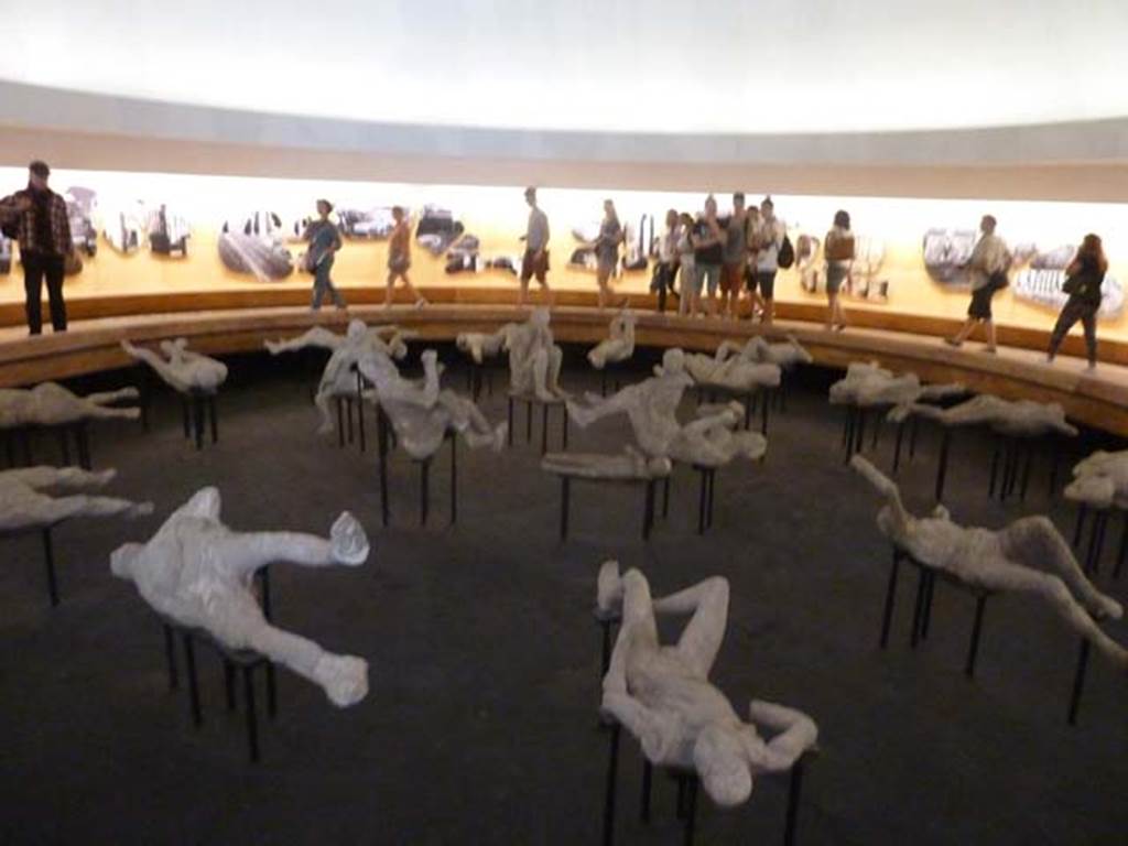 Pompeii, September 2015. Exhibits from the Summer 2015 exhibition in the amphitheatre. Victim numbered 1, found in the area of Reg VII, between Insulae 10,11,13 and 14, can be seen on the lower left.