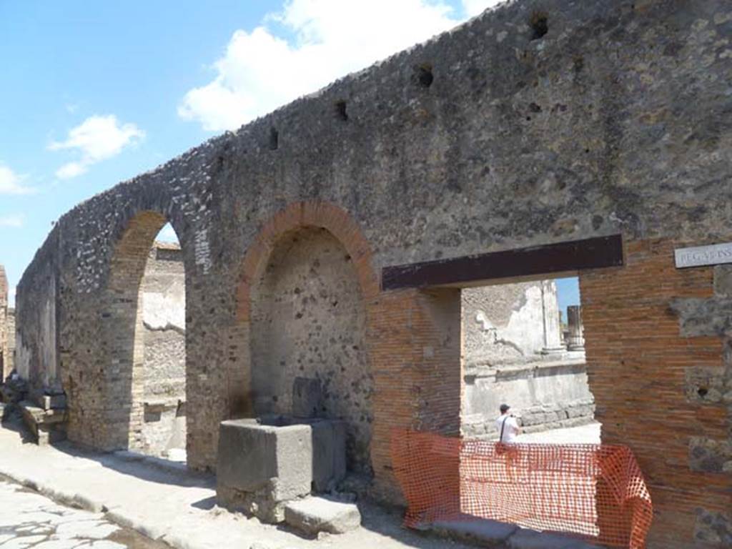 Vicolo dei Soprastanti, south side, May 2011. Looking east along VII.8, wall and entrances of the Forum. Photo courtesy of Michael Binns.