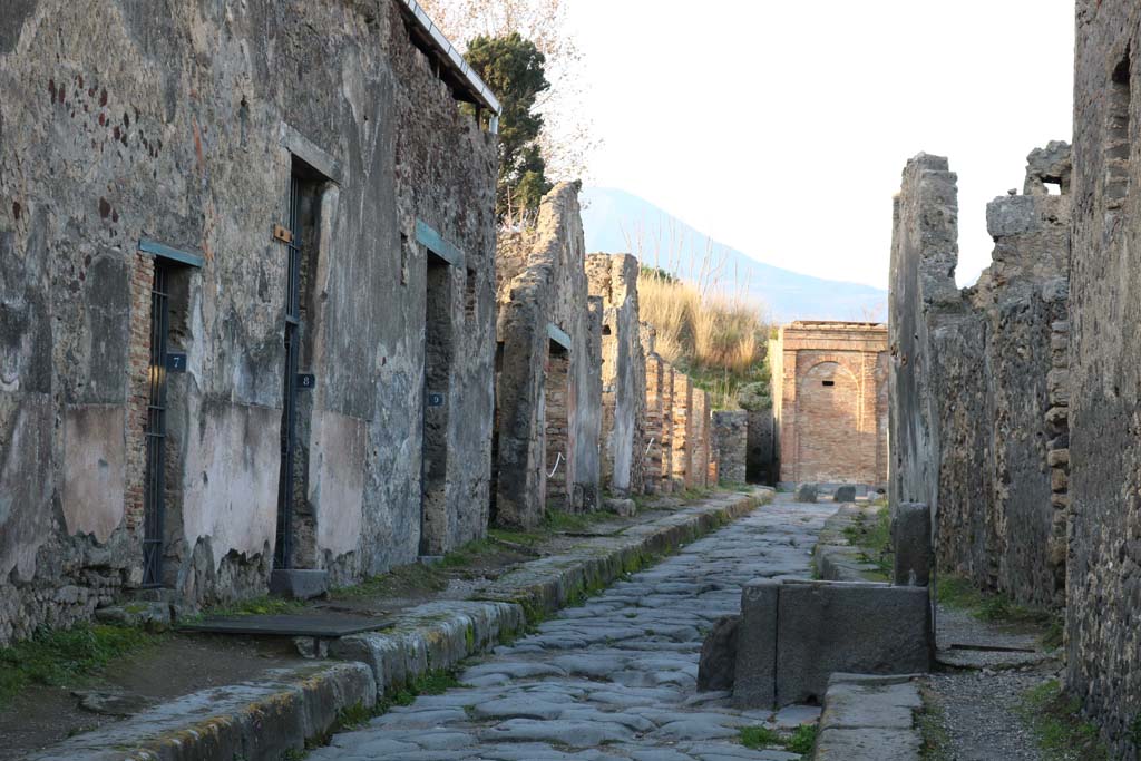Vicolo dei Vettii between VI.15 and VI.16. December 2018. 
Looking north from VI.15.7, on left, towards VI.15.18, in centre near water tower. Photo courtesy of Aude Durand.