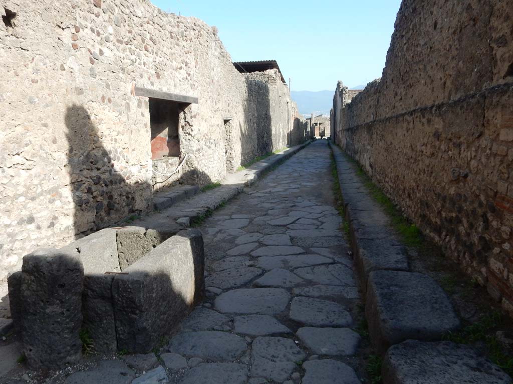 Vicolo del Labirinto, Pompeii. June 2019. Looking south along the east side, with fountain outside VI.13.7, on left.
Photo courtesy of Buzz Ferebee.