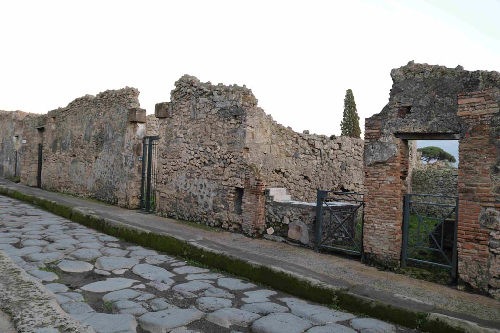 Vicolo del Menandro, (south side) Pompeii. December 2018. 
Looking east along 1.3, between doorways of I.3.24, 23, 22 and 21. Photo courtesy of Aude Durand.