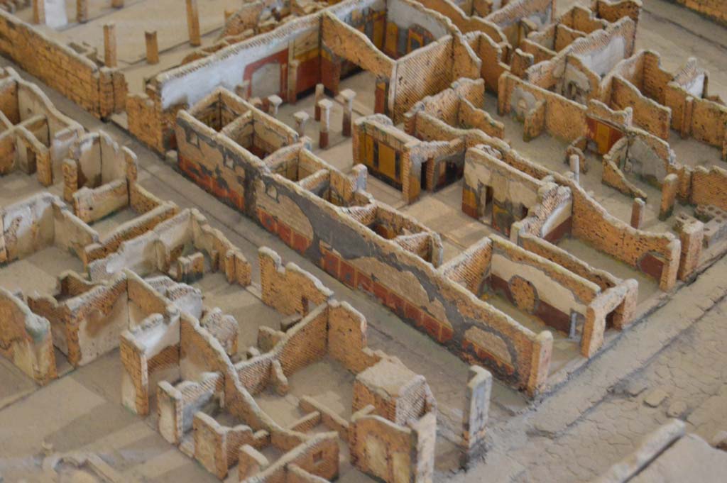 Vicolo della Fullonica between VI.6 and VI.8, in centre. Detail from model in Naples Archaeological Museum.
Looking towards east wall of roadway, exterior wall of VI.8.3/5, the House of the Tragic Poet. 
Foto Taylor Lauritsen, ERC Grant 681269 DÉCOR.