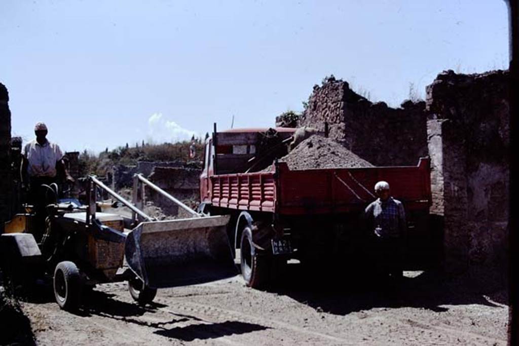 Looking west on Via della Palestra at junction with Vicolo della Nave Europa. Pompeii. 1972. Removal of lapilli. Photo by Stanley A. Jashemski. 
Source: The Wilhelmina and Stanley A. Jashemski archive in the University of Maryland Library, Special Collections (See collection page) and made available under the Creative Commons Attribution-Non Commercial License v.4. See Licence and use details. J72f0705