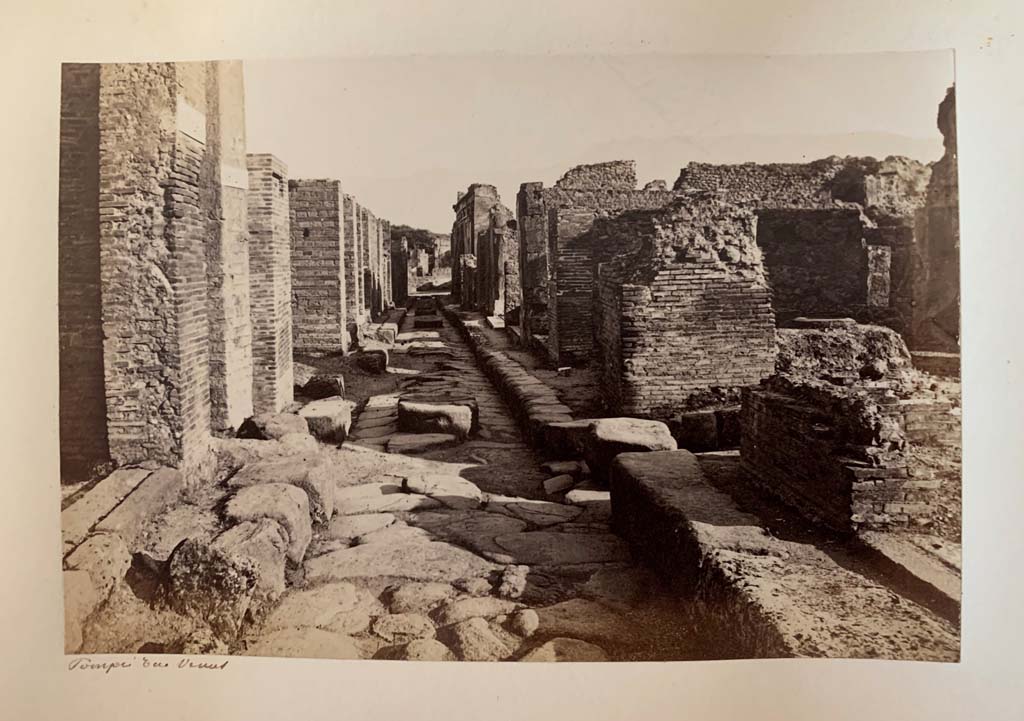 Vicolo di Eumachia, Pompeii, described as Rue? Venus. 
From an Album by M. Amodio, c.1880, entitled “Pompei, destroyed on 23 November 79, discovered in 1748”.
Looking south from junction with Vicolo del Balcone Pensile, (centre left and right). Photo courtesy of Rick Bauer.