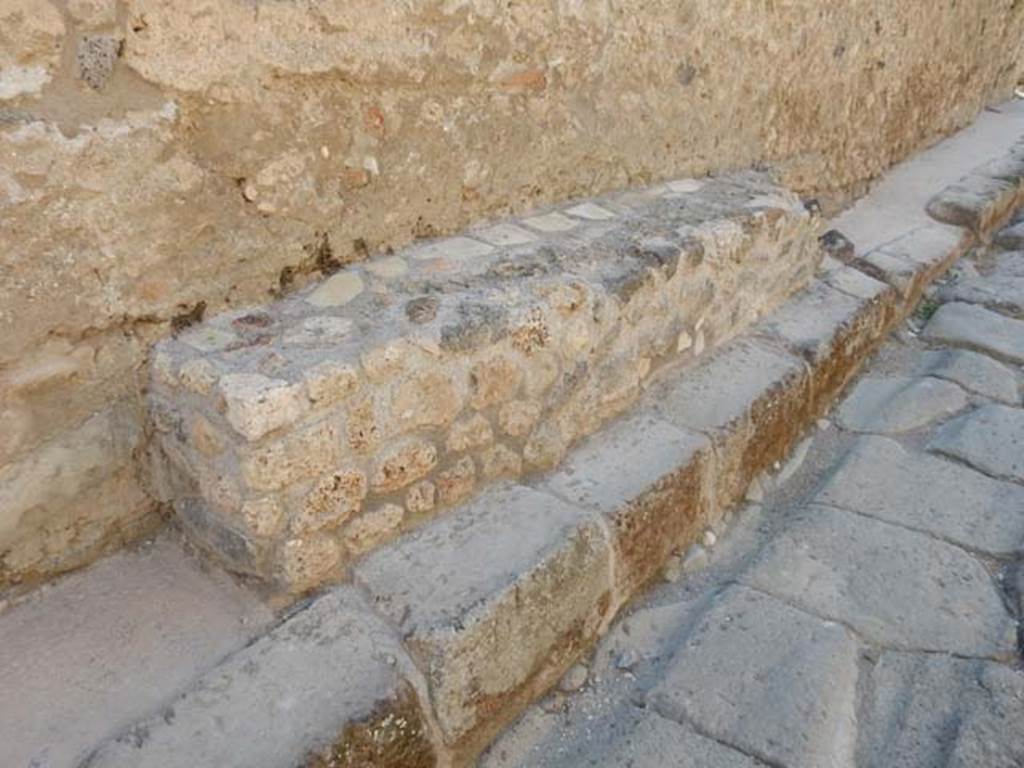 Vicolo di Tesmo, Pompeii. May 2017. Looking north along west side at bench outside of IX.3.20. Photo courtesy of Buzz Ferebee.