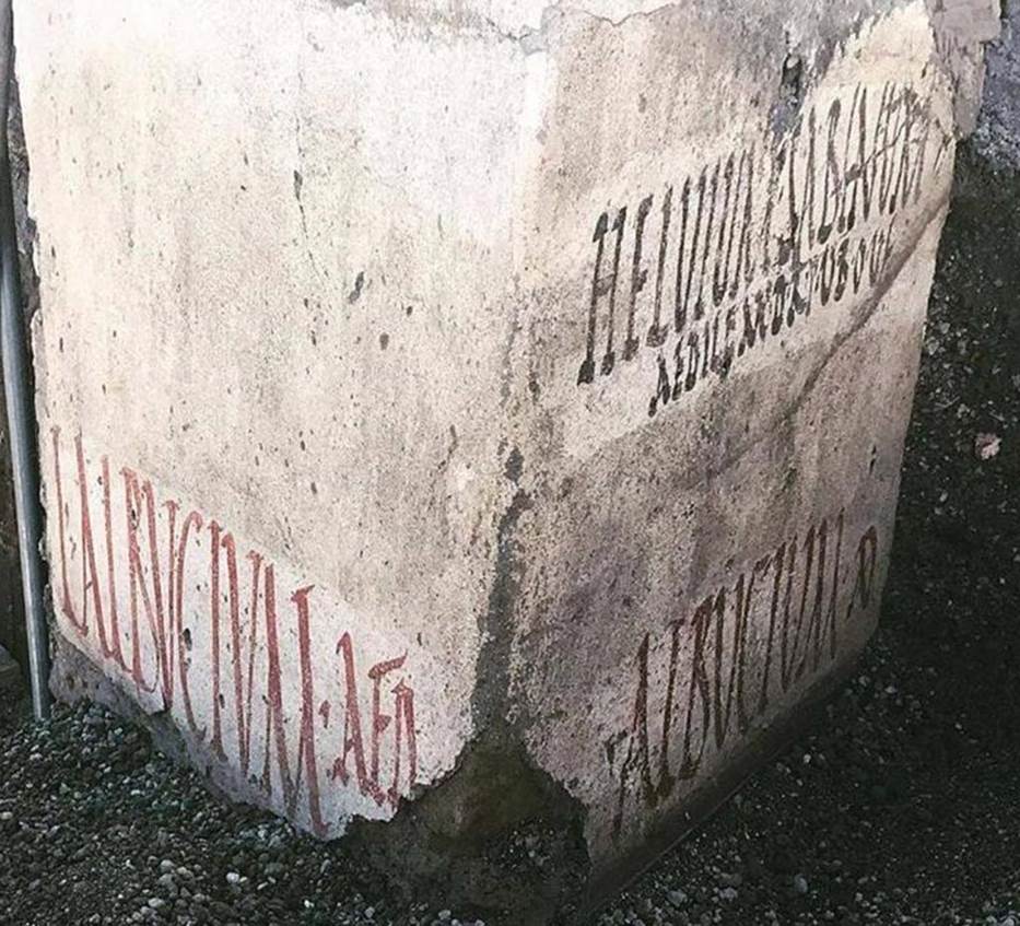 Vicolo delle Nozze Argento, at junction with Vicolo dei Balconi. Three electoral inscriptions at north-west corner of junction.
On the East wall are two inscriptions:
In black above is the inscription
HELVIUM SABINUM
AEDILEM D R P V B O V F
Helvium Sabinum
aedilem d(ignum) r(ei) p(ublicae)
v(irum) b(onum) o(ro) v(os)
f(aciatis)
In red below is the inscription:
ALBVCIVM AED
Electoral inscription on the south wall: 
L ALBVCIVM AED
L(ucium) Albucium aed(ilem). 
The Albucii were probably the owners of the House of the Silver Wedding.
The inscriptions were made on a layer of white paint, perhaps done to cover previous inscriptions and in any case to ensure a clear writing surface for the preserved inscriptions, which refer to the last electoral campaign of Pompeii before 79AD.
Photograph © Parco Archeologico di Pompei.