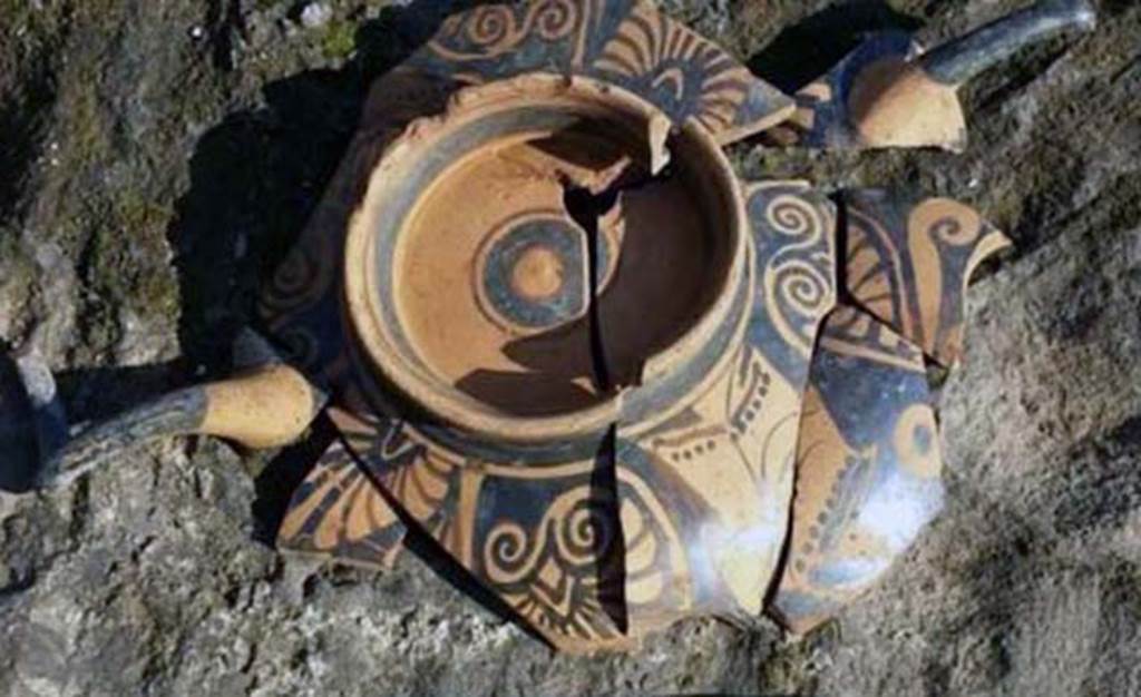 Santuario extraurbano del Fondo Iozzino. 2014. Decorated pottery with two horn style handles.
According to the PAP website, the most striking aspect of the finds dated to the Archaic Age is the sheer quantity of bucchero pottery with engraved inscriptions in the Etruscan language, which represents the largest corpus of Etruscan inscriptions yet found in a single context in Southern Italy. The bucchero pottery was employed in sacrifices which saw offerings of red or white wine, or herbal infusions, to the gods. 
The inscriptions were made on the basin and on the feet of the bowls and banquet vases, which after usage were deposited upside down on the ground.
These inscriptions reveal the names of those who made the offerings - Etruscans who also came from Tuscany, and of the deities to whom the sanctuary was dedicated - the god ‘apa’ or ‘father’ - perhaps Jupiter Meilichios. 
L’aspetto più eclatante dei ritrovamenti riferibili all’età arcaica è costituito dalla notevole quantità di vasellame in bucchero con iscrizioni graffite in lingua etrusca che rappresenta il più grande corpus di iscrizioni etrusche fino ad ora rinvenuto in un unico contesto in Italia meridionale. Il vasellame in bucchero era utilizzato per sacrifici che prevedevano l’offerta alle divinità di vino rosso e bianco, o infusi d’erbe.
Le iscrizioni erano poste sulla vasca e sul piede di scodelle e di vasi da banchetto che, dopo l’uso, venivano deposti capovolti sul suolo. 
Queste iscrizioni rivelano i nomi degli offerenti, etruschi che provenivano anche dalla Toscana, e della divinità a cui era dedicato il santuario, il dio “apa” “padre”, forse Giove Meilichios.
Photograph © Parco Archeologico di Pompei.
