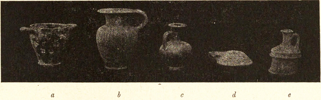 Pompeii Fondo Azzolini. Tomb XII. Vessels found in tomb.
In this tomb were two vessels, (as tomb VI types e and d) with a black glazed skyphos 0.09m high (as in Fig. 5, a), an ovoid ointment jar, 0.12 m high, and fragments of an iron strigil.
See Notizie degli Scavi di Antichità, 1916, p. 294, fig. 5a.
Nine tombs had single coins found in them but this tomb was one of only two that had two coins found in them. One was a bronze coin of Nuceria with the head of a youth and a greyhound running to the right and with an Oscan inscription. It was found in the mouth of the deceased.
The second was a small silver scifata (cup shaped) coin from Phistelia. It was found in one of the funerary vessels, an olpe (flask).
See Notizie degli Scavi di Antichità, 1916, p. 295.