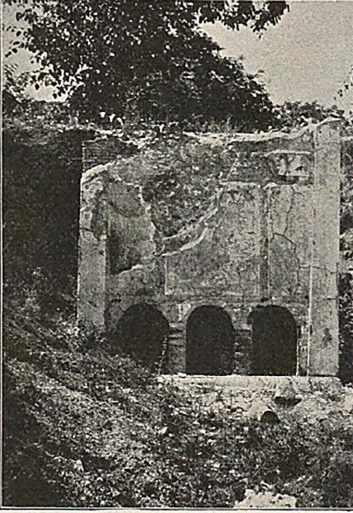 FP3 Pompeii. Detail from late 19th century photo.
The tomb has a vaulted sepulchral chamber entered from the rear. 
On the inside of the wall next to the street were three niches. Each niche contained an urn.
Directly over the inner niches, and opening to the street, are three other niches (seen in this photo).
Each had a libation tube allowing relatives to pour oil and wine on to the urns inside.
Lava bust stones, one with the appearance of a woman, were placed at the back of the three outer niches.
See Mau, A., 1907, translated by Kelsey F. W. Pompeii: Its Life and Art. New York: Macmillan. (p. 434-5).