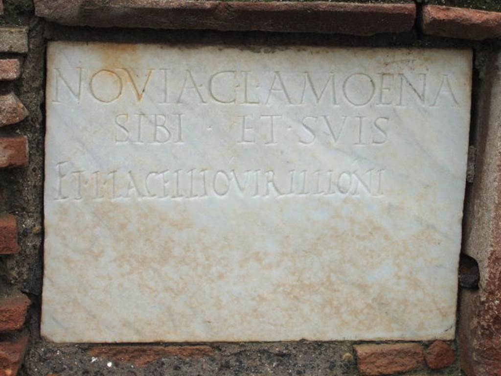 FPNE Pompeii. December 2005. Marble plaque in centre of brick pilaster in tomb.
The inscription reads 
NOVIA C. L. AMOENA 
SIBI ET SVIS 
ET L. IACELLIO VIRILLIONI.
D’Ambrosio and De Caro expand this to:
Novia C(ai) l(iberta) Amoena 
sibi et suis 
et L(ucio) Iacellio Virillioni
See D’Ambrosio A. and De Caro S., 1988. Römische Gräberstraßen. München: C.H.Beck. p. 208.