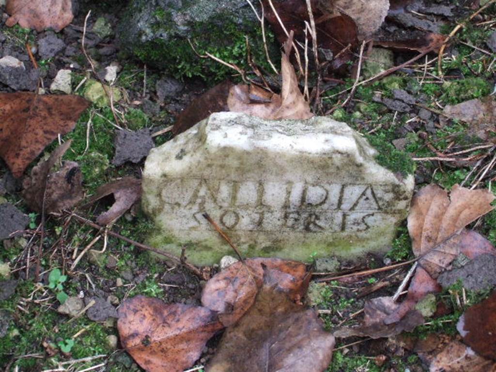 FPSG Pompeii. December 2005. Marble columella of Callidia Soteris.
This has the inscription 
CALLIDIA 
SOTERIS.
On the back (the upper part is now missing) was a parting line and a bun, schematically represented as an incised triangle.
See D’Ambrosio A. and De Caro S., 1988. Römische Gräberstraßen. München: C.H.Beck. p. 225, taf. 39d.