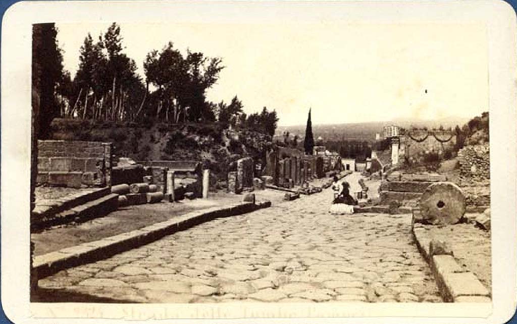 Via dei Sepolcri. Old photo c.1869 by G. Sommer, no. 2325. 
Looking west along the Via dei Sepolcri past the offset crossroads with Via Pomeriale.
The lady is sitting at the front of HGE03, on the corner of the Via Pomeriale.
Photo courtesy of Giovanni Dall'Orto, Wikimedia Commons. See on Wikimedia Commons.