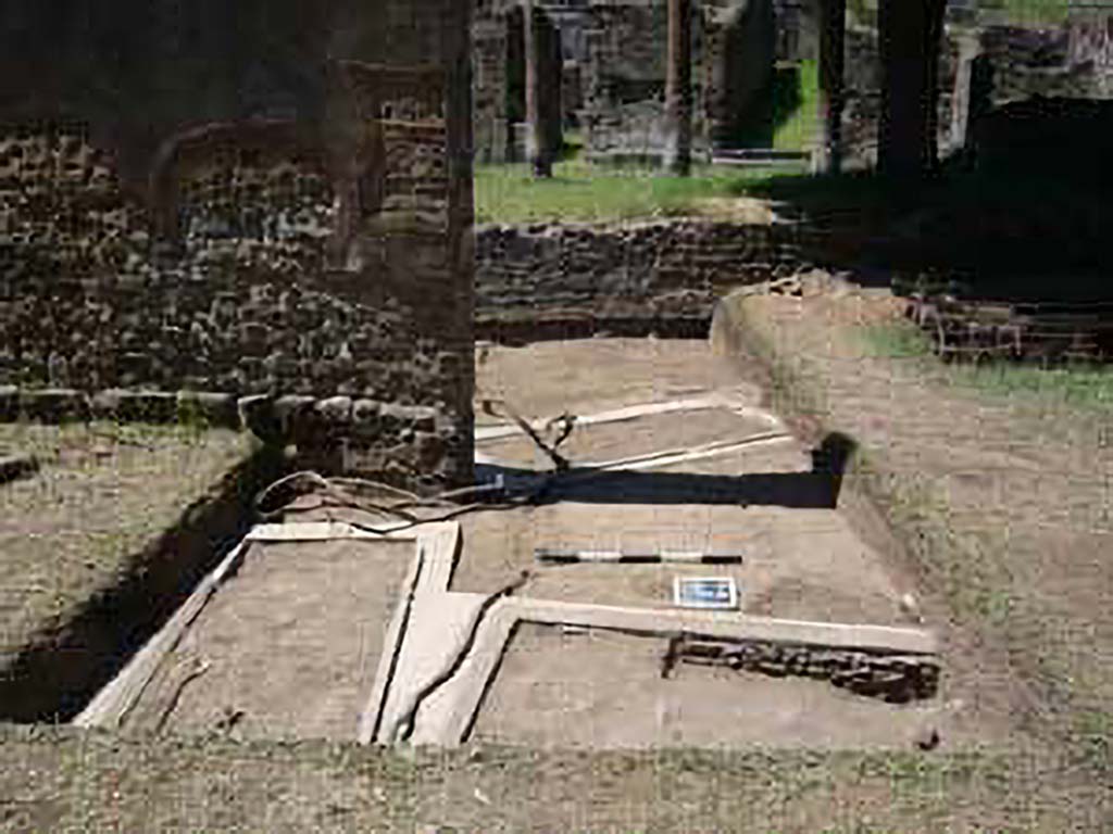 HGE15A Pompeii. 2009 re-excavation of three Samnite graves by the Via Consolare Project. 
The location of three graves is clustered around the base of the wall. 
The two graves in the metal frames are also visible on the other side of the gap in the wall.
Excavations in 2009 were carried out by the Via Consolare Project and their report commented that:
Extensive modern deposits were removed from the area, revealing three heavily reconstructed, irregularly-aligned inhumation cist-graves. 
It is likely that these constructions are the result of the excavations of A. Maiuri in the 1930-40’s and were a component of his preparations of the Villa for general display that included replanting the viridarium and running water to the nymphaeum.
Photo courtesy of the Via Consolare Project. See http://www.viaconsolareproject.org/research2009.html