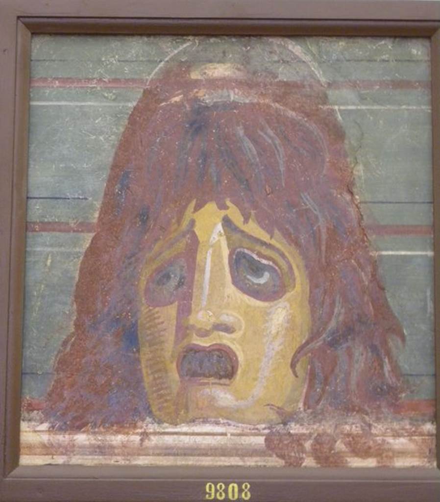 HGW04 Pompeii.  Schola Tomb of Mamia, wall painting of mask. Found 2nd July 1763 on the north wall of the enclosure separating HGW04 from HGW04a.  Now in Naples Archaeological Museum.  Inventory number 9808. See Pagano, M. and Prisciandaro, R., 2006. Studio sulle provenienze degli oggetti rinvenuti negli scavi borbonici del regno di Napoli. Naples : Nicola Longobardi.  (p. 44).