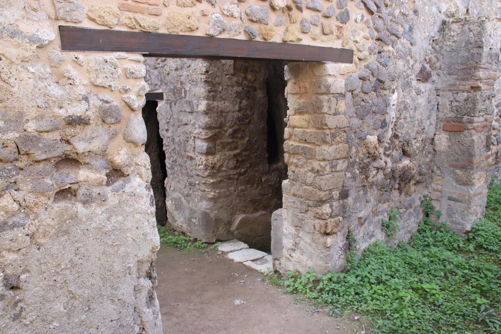 HGW25 Pompeii. Part of Villa of Diomedes. October 2023. 
Looking towards south wall with doorway leading into Villa. Photo courtesy of Klaus Heese.