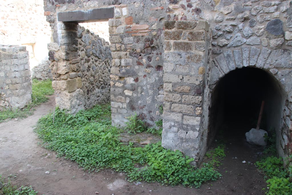 HGW25 Pompeii. Part of Villa of Diomedes. October 2023. 
East end of room 7,6 with doorway to room 7,7 and arched entrance to cellar. Photo courtesy of Klaus Heese.