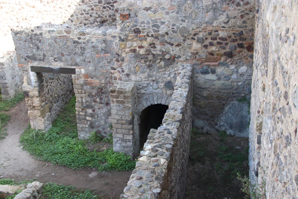 HGW24 Pompeii. Villa of Diomedes. October 2023. 
Looking east towards doorway to room 7,7, arched entrance, and east end of passageway 6,b. Photo courtesy of Klaus Heese.