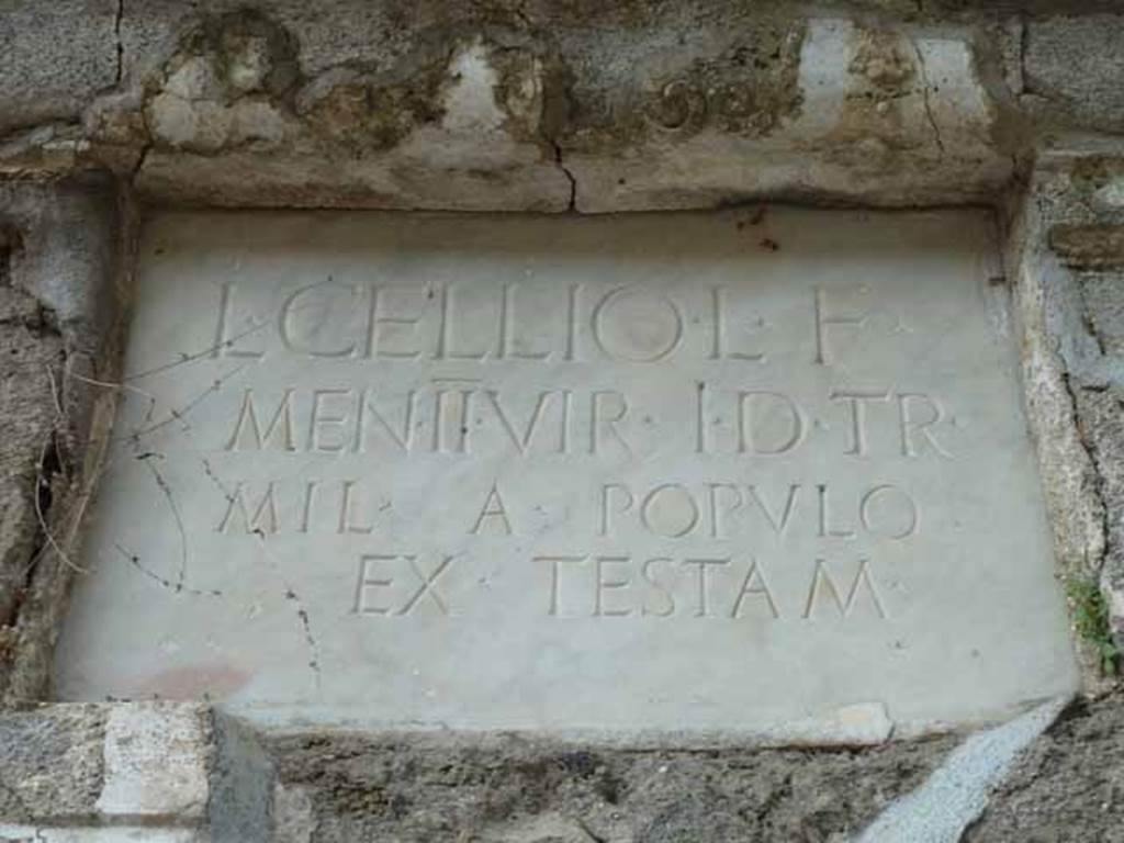 Pompeii Porta Nocera. May 2010. Tomb 4EN, marble plaque with latin inscription:
L(ucio)   CELLIO   L(uci)   F(ilio)
MEN(enia)   II VIR  (duo vir(o))   I(ure)   D(icundo)  TR(ibuno)
MIL(itum)   A   POPVLO
EX  TESTAM(ento).
See D’Ambrosio, A. and De Caro, S., 1983. 
Un Impegno per Pompei: Fotopiano e documentazione della Necropoli di Porta Nocera. 
Milano: Touring Club Italiano. (4EN).