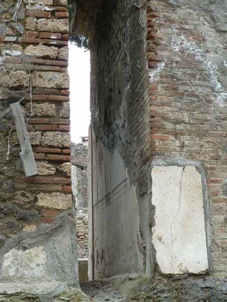 Pompeii Porta Nocera. May 2010.
Space between 12EN and 10EN, with remains of plaster on 10EN. Looking south.