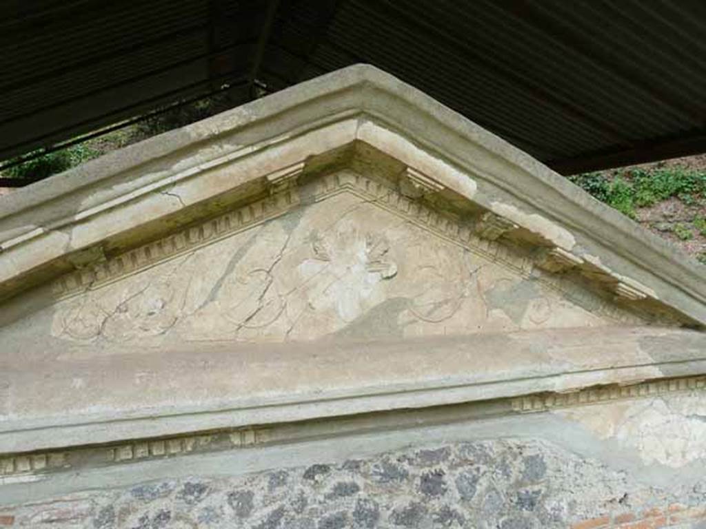 Pompeii Porta Nocera. May 2010. Tomb 34aEN. 
Detail of decoration on west side of aedicula on podium.