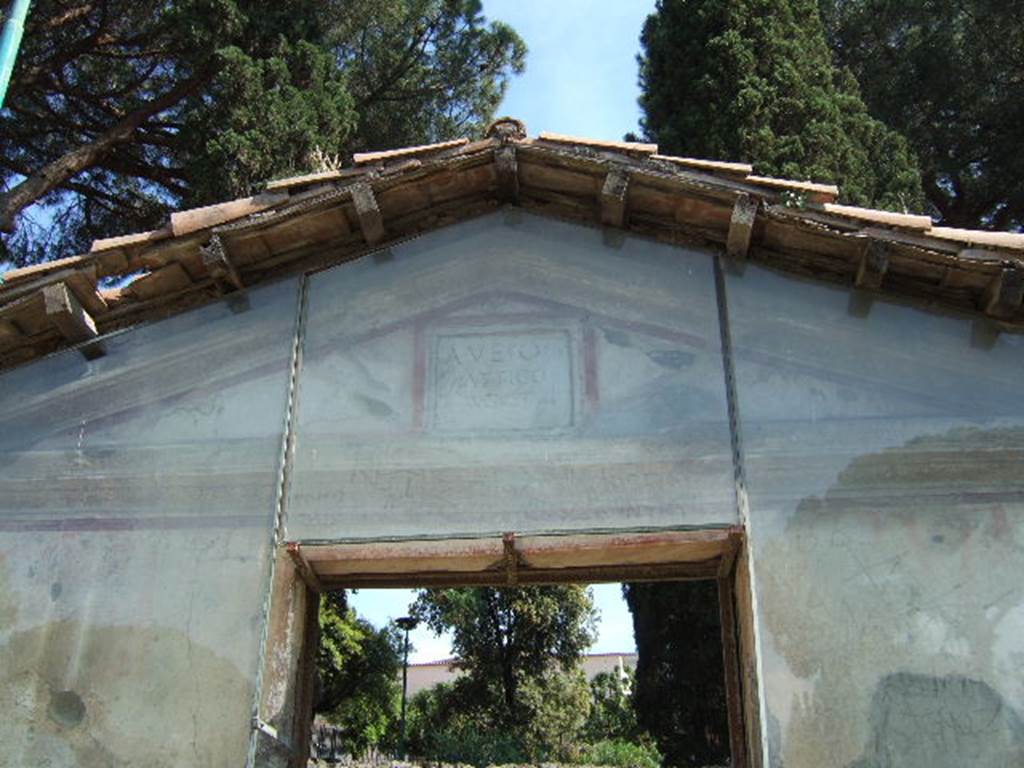 Pompeii Porta Nocera. Tomb 11ES. May 2006. Triangular top with cornice around all three sides and marble plaque above the door.