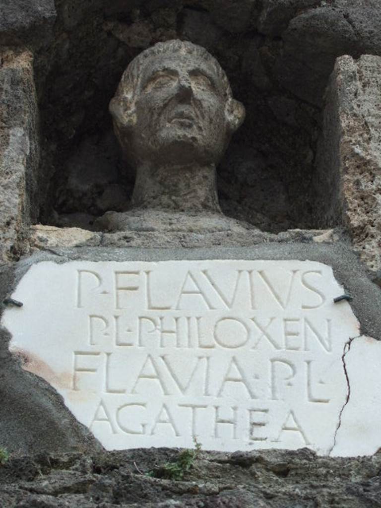 Pompeii Porta Nocera Tomb 7OS. May 2006. Bust and marble plaque with inscription.
P(ublius)  FLAVIVS
P(ubli)  L(ibertus)  PHILOXEN(us)
FLAVIA  P(ubli)  L(iberta)
AGATHEA.