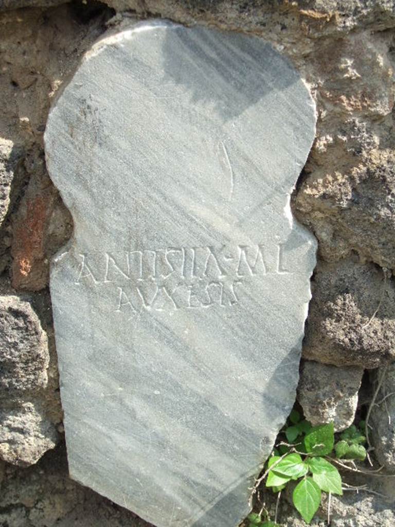 Pompeii Porta Nocera Tomb 15OS.  May 2006. Marble columella set in wall of the enclosure or recinto of Eumachia.  This has the inscription
ANTISTIA  M(arci)  L(iberta)
AVXESIS.