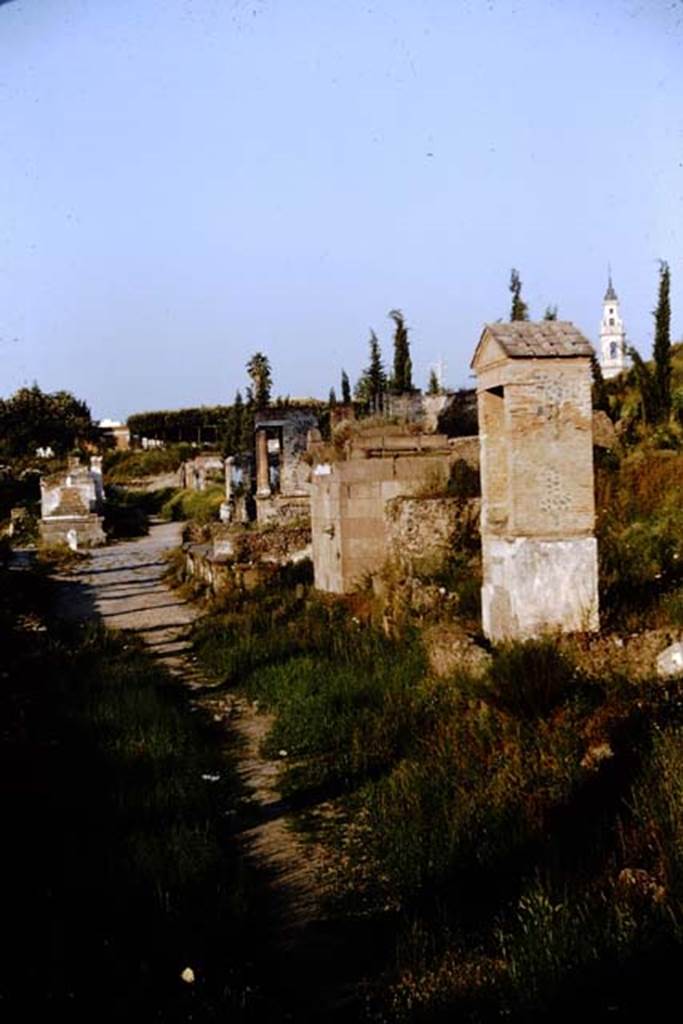 Pompeii Porta Nocera Tomb 23OS, on the right.  Looking east along Via delle Tombe. 1964. Photo by Stanley A. Jashemski.
Source: The Wilhelmina and Stanley A. Jashemski archive in the University of Maryland Library, Special Collections (See collection page) and made available under the Creative Commons Attribution-Non Commercial License v.4. See Licence and use details.
J64f1653