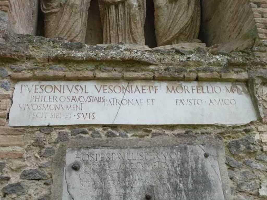 Pompeii Porta Nocera Tomb 23OS. May 2010.
Marble plaque with latin inscriptions.
P(ublius)  VESONIVS  G(aiae)  L(ibertus)
PHILEROS  AVGVSTALIS
VIVOS  MONVMENT(um)
FECIT  SIBI  ET  SVIS
VESONIAE  P(ubli)  F(iliae)
PATRONAE  ET
M(arco)  ORFELLIO  M(arci)  L(iberto)
FAVSTO  AMICO.