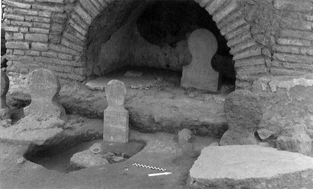 Pompeii Porta Nocera. Tomb 23OS. Columellae at rear of tomb.
The two freedmen's graves are placed side by side in the niche underneath the monument. The patroness's burial is placed in front of the monument, on the left side.
In the centre is the columella of the son of P. Vesonius Phileros, Publius Vesonius Proculus who lived 13 years.
See Lepetz S. and Van Andringa W., 2011. Publius Vesonius Phileros vivos monumentum fecit-.Investigations in a sector of the Porta Nocera cemetery in Roman Pompeii. p. 117, Fig. 6.5.
(photo, A. Cailliot, MFP/FPN).
