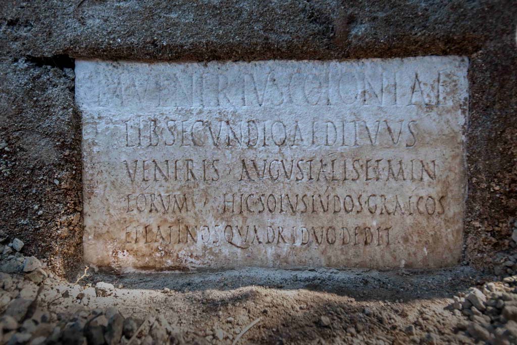 Porta Sarno la tomba di Marcus Venerius Secundio. August 2021. 
On a marble slab located on the pediment of the tomb, a commemorative inscription to the owner Marcus Venerius Secundio makes reference, extraordinarily, to performances at Pompeii that were conducted in Greek, direct evidence of which has never before been found.
The figure of Marcus Venerius Secundio - who also appears in the wax tablet archive of the Pompeian banker Caecilius Giocondo, owner of the domus of the same name on Via Vesuvio - was a public slave and custodian of the Temple of Venus. Upon being freed, he reached a certain social and economic status, as can be understood from the rather monumental tomb, and the inscription: in addition to joining the ranks of the Augustales, or the college of priests dedicated to the Imperial Cult, as the epigraph recalls he "gave Greek and Latin ludi for the duration of four days". "Ludi graeci are to be understood as performances in the Greek language': - observes the Director of the Archaeological Park of Pompeii, Gabriel Zuchtriegel.
Sulla lastra marmorea posta sul frontone della tomba un'iscrizione commemorativa del proprietario Marcus Venerius Secundio richiama, straordinariamente, lo svolgimento a Pompei di spettacoli in lingua greca, mai prima attestati in maniera diretta.
Il personaggio di Marcus Venerius Secundio - che compare anche nell'archivio di tavolette cerate del banchiere pompeiano Cecilio Giocondo, proprietario della domus omonima su via Vesuvio – era uno schiavo pubblico e custode del tempio di Venere. Una volta liberato, aveva poi raggiunto un certo status sociale ed economico, come emergerebbe non solo dalla tomba piuttosto monumentale, ma anche dall'iscrizione: oltre a diventare Augustale, ovvero membro del collegio di sacerdoti dediti al culto imperiale, come ricorda l'epigrafe, "diede ludi greci e latini per la durata di quattro giorni". "Ludi graeci è da intendere come spettacoli in lingua greca - commenta il direttore del Parco archeologico di Pompei, Gabriel Zuchtriegel.
M VENERIVS COLONIAE
LIB SECUNDIO AEDITVVS
VENERIS AVGVSTALIS ET MIN
EORVM HIC SOLVS LVDOS GRAECOS
ET LATINOS QVADRIDVO DEDIT
Photograph © Parco Archeologico di Pompei.
According to Virginia Campbell the reads as:
M(arcus) Venerius coloniae
lib(ertus) Secundio, aedituus
Veneris, Augustalis et min(ister)
eorum. Hic solus ludos Graecos
et Latinos quadriduo dedit.
And translates as:
‘Marcus Venerius Secundio, freedmen of the colony, guardian of the temple of Venus, Augustalis and minister of them. He, on his own, gave Greek and Latin games for four days.
See https://pompeiinetworks.wordpress.com/2021/08/19/the-tomb-of-marcus-venerius-secundio/