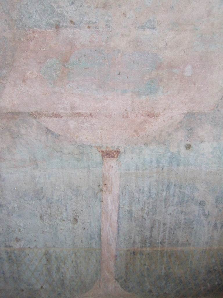 VGJ Pompeii.  May 2006.  Inner side of east wall of tomb.  Garden painting with low lattice fence.  A bowl fountain with a square brim stands in front of the fence and is supported by a tall slender pedestal.