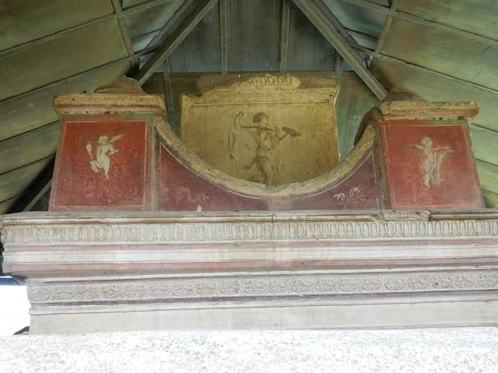 VGJ Pompeii. May 2015. South side of inner tomb with carved marble figure and paintings of cupids. Photo courtesy of Buzz Ferebee.