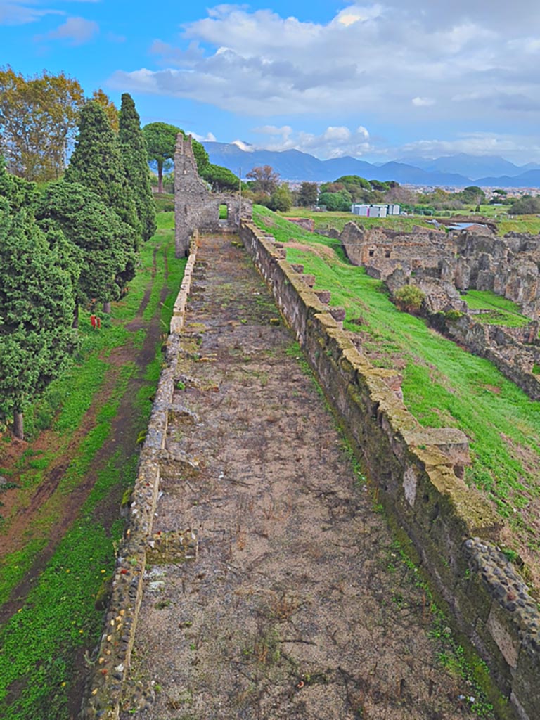 Tower XI, Pompeii. November 2023. 
Looking east along top of wall towards Tower X, from upper floor level. Photo courtesy of Giuseppe Ciaramella.