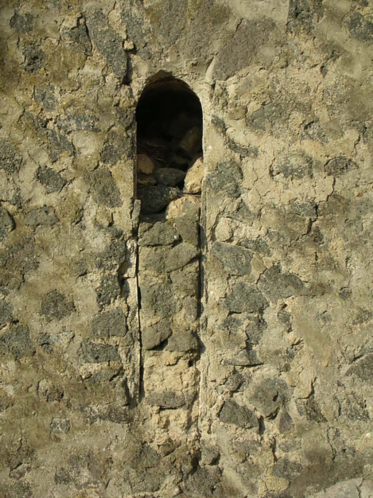 Tower XI, Pompeii. May 2010. 
Partially blocked arrow slit window on west wall in north-west corner. Photo courtesy of Ivo van der Graaff.