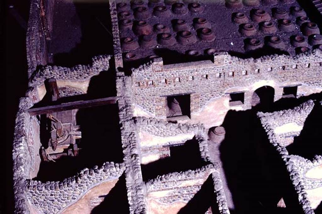 Villa della Pisanella, Boscoreale. 1972. Photograph from model of Villa, room T, the olive press room can be seen in the centre-left.
Room S, the corridor that contained the vessels for the oil can be seen in the centre-right, with arched doorway leading to room Q, cella vinaria.
Photo by Stanley A. Jashemski. 
Source: The Wilhelmina and Stanley A. Jashemski archive in the University of Maryland Library, Special Collections (See collection page) and made available under the Creative Commons Attribution-Non-Commercial License v.4. See Licence and use details.
J72f0514