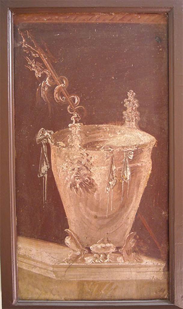 Villa of P. Fannius Synistor at Boscoreale. Peristyle E. Painting of a situla placed on a podium as an athletic winner’s reward. It has three low feet in the form of feline legs, with a tapered body with a high lip slightly turned. The handles are in the form of Silenus masks.
Outside the bowl hang the ribbons of the winner, while behind it, and placed obliquely a trident with twisted a fantastic animal. Now in Naples Archaeological Museum.  Inventory number s.n. 7. See Sampaolo V. and Bragantini I., Eds, 2009. La Pittura Pompeiana. Electa: Verona. 56b, p. 176.