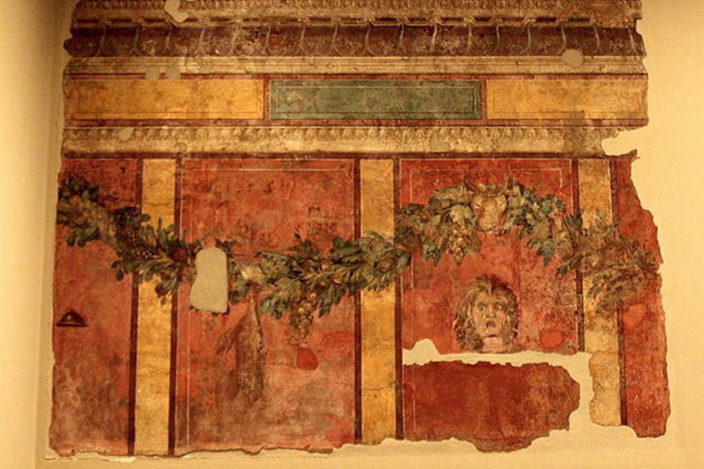 Villa of P. Fannius Synistor at Boscoreale. Room L, tablinum, rear wall. 
Garlands are supported by a ceremonial bulls head.
A satyr mask is in right hand panel which would have been the centre of the wall.
In the panel to the left of the mask a dead hare is suspended from the garland.
In the panel to the far left is a small cymbal (cymbalum).
Photo courtesy of Michel Wal, Wikimedia Commons. 
This photo is subject to an Attribution-ShareAlike 3.0 Unported licence.
Now in the Musée Royal de Mariemont, Morlanwelz, Belgium. Inventory number R61.
http://www.musee-mariemont.be/
