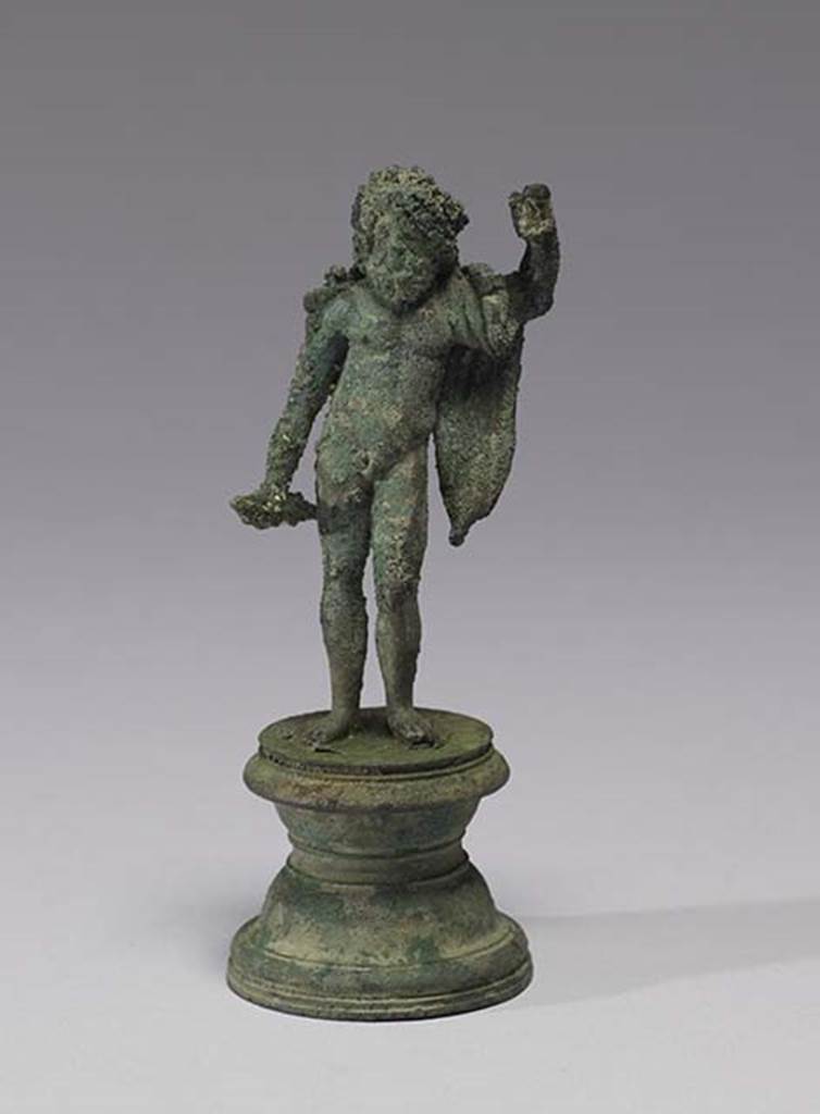Boscoreale, Villa rustica in fondo D’Acunzo.Room 12, lararium. 
Bronze statuette of standing Jupiter, 0.10m high, front view.
According to Della Corte, the statue depicted Neptune, bearded, nude except for a mantle over his left shoulder. 
In his right was possibly a dolphin, the left was raised like that of Jupiter, as if supported upon a sceptre or trident, now missing. 
Both attributes, perhaps, were made of wood.
See Notizie degli Scavi di Antichità, 1921, p. 440.
According to Stefani, the different. and more plausible interpretation proposed by others is an image of Jupiter.
See Stefani G., 2000. In Sylva Mala, Bollettino del Centro Studi Archeologici di Boscoreale, Boscotrecase e Trecase XII, p. 15 and note 44.
Photo courtesy of The Walters Art Museum, Baltimore. Inventory number 54.749.
http://thewalters.org/
Creative Commons Attribution-ShareAlike 3.0 Unported Licence