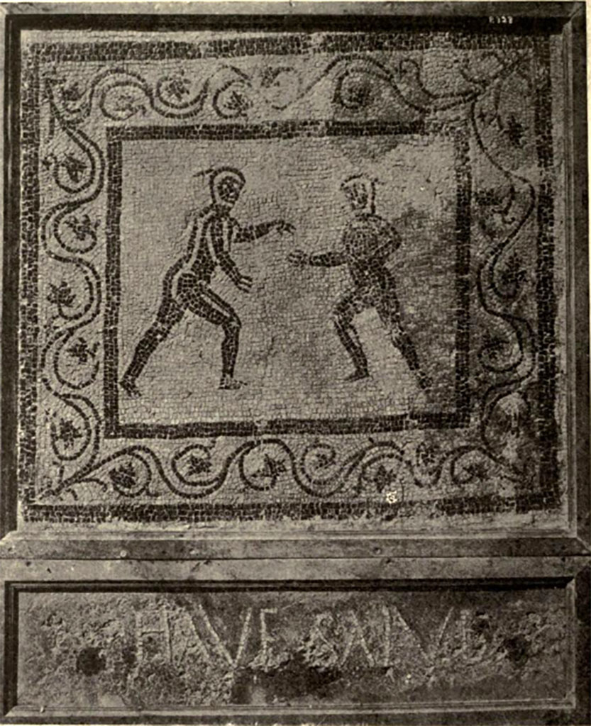 Boscoreale. Villa of Numerius Popidius Florus. Frigidarium 7. Emblema mosaic with two nude wrestlers and the threshold greeting HAVE SALVE.
See Notizie degli Scavi di Antichità, 1921, p.450, fig. 15.