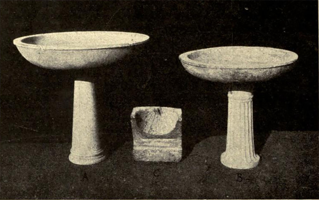 Boscoreale. Villa of Numerius Popidius Florus. Marble finds of two basins and a sundial.
Left: Labrum from calidarium 10.
Centre: Sundial in Nocera tufa (found at f on plan).
Right: Portasanta basin on fluted white marble column from frigidarium 7.
See Notizie degli Scavi di Antichità, 1921, p. 452 fig. 17.
See Garcia y Garcia L., 2017. Scavi Privati nel Territorio di Pompei. Roma: Arbor Sapientiae, p. 379, p. 388, p. 389.