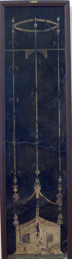Villa of Agrippa Postumus. Boscotrecase. Room 15, black room, east wall.
Panel with slender architectural features, triangular in plan.
Now in Naples Archaeological Museum.  Inventory number 138992.