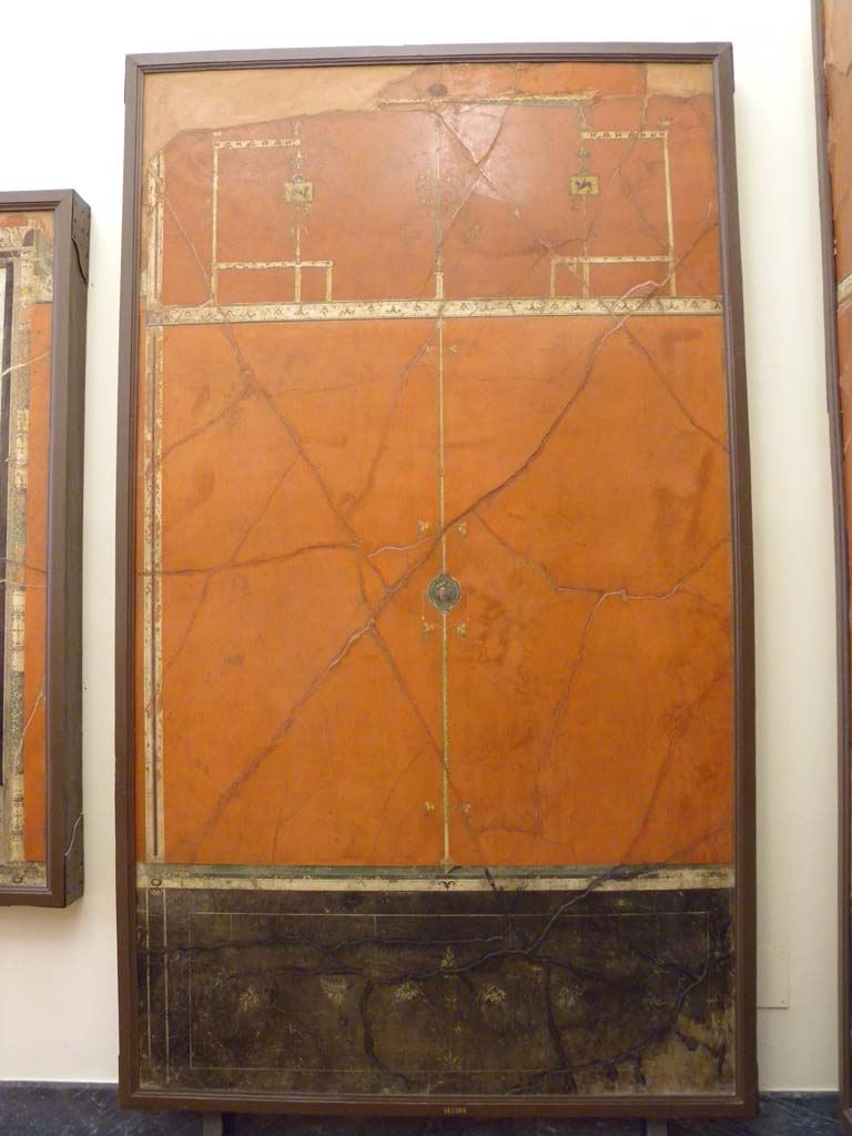 Villa Agrippa Postumus. Boscotrecase. Room 16, west wall.
The ante-room wall is dominated by small panels crossed by a particularly slender candelabrum motif with branches. 
This continues up into the higher part of the wall where it is flanked by symmetrical architectural elements.
Now in Naples Archaeological Museum. Inventory number 147504.