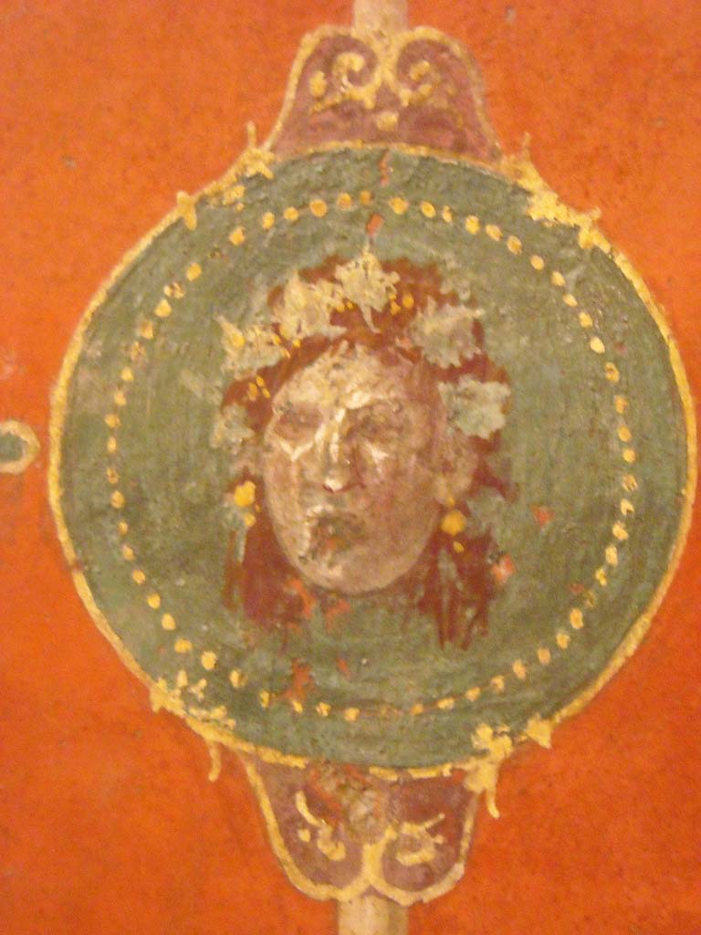 Villa Agrippa Postumus. Boscotrecase. 
Room 16, detail of mask from centre of panel on west wall at north end.
Now in Naples Archaeological Museum. Inventory number 147504.