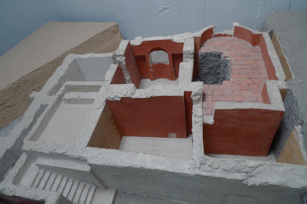 Complesso dei triclini in località Moregine a Pompei. July 2010. Baths suite looking north on December 2000 model.
Photo courtesy of Michael Binns.
Left to right are steps G, 8, 7 (front), service areas 9, 10, N and 2 (behind) and apodyterium S, tepidarium O and caldarium 3 (at rear).
The building was reoccupied immediately after the eruption of 79 A.D.
Evident traces are the tiled floors made over the volcanic earth in rooms 3 and O. 
See De Simone, A., 2000. L’indagine archeologica in località Murecine a Pompei, in A. De Simone e S. C. Nappo (a cura di), Mitis Sarni Opes, Napoli, 2000, p. 75
