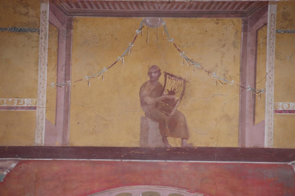 Oplontis Villa of Poppea, October 2022. 
Room 8, painted upper centre of east wall with painting of a poet playing the lyre. Photo courtesy of Klaus Heese.